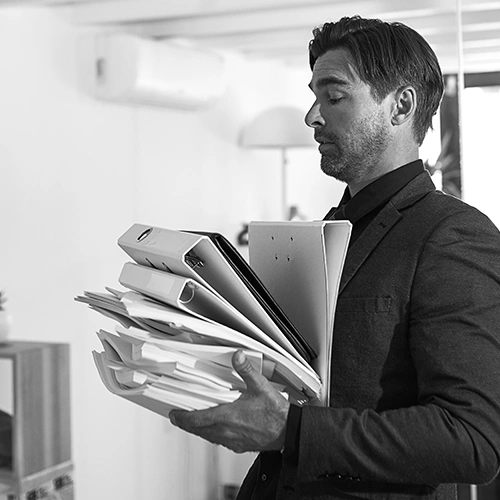 business owner carrying too much paperwork